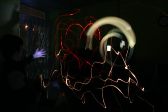 this is a photograph taken in the dark, with trails of moving white and coloured lights