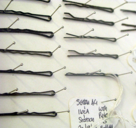 close up of hair grips, pinned inside a display case.